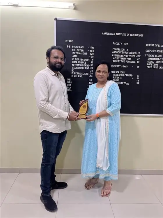 Anand receiving a memento from AIT faculty