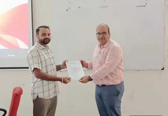 Anand Shrivastava receiving a certificate of appreciation from GTU ITR faculty