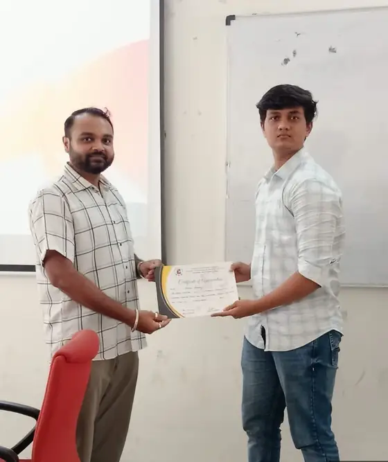 Diploma student receiving a completion certificate from Anand at GTU ITR