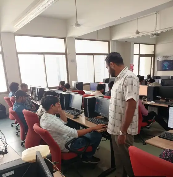 Anand helping a diploma student at his workstation