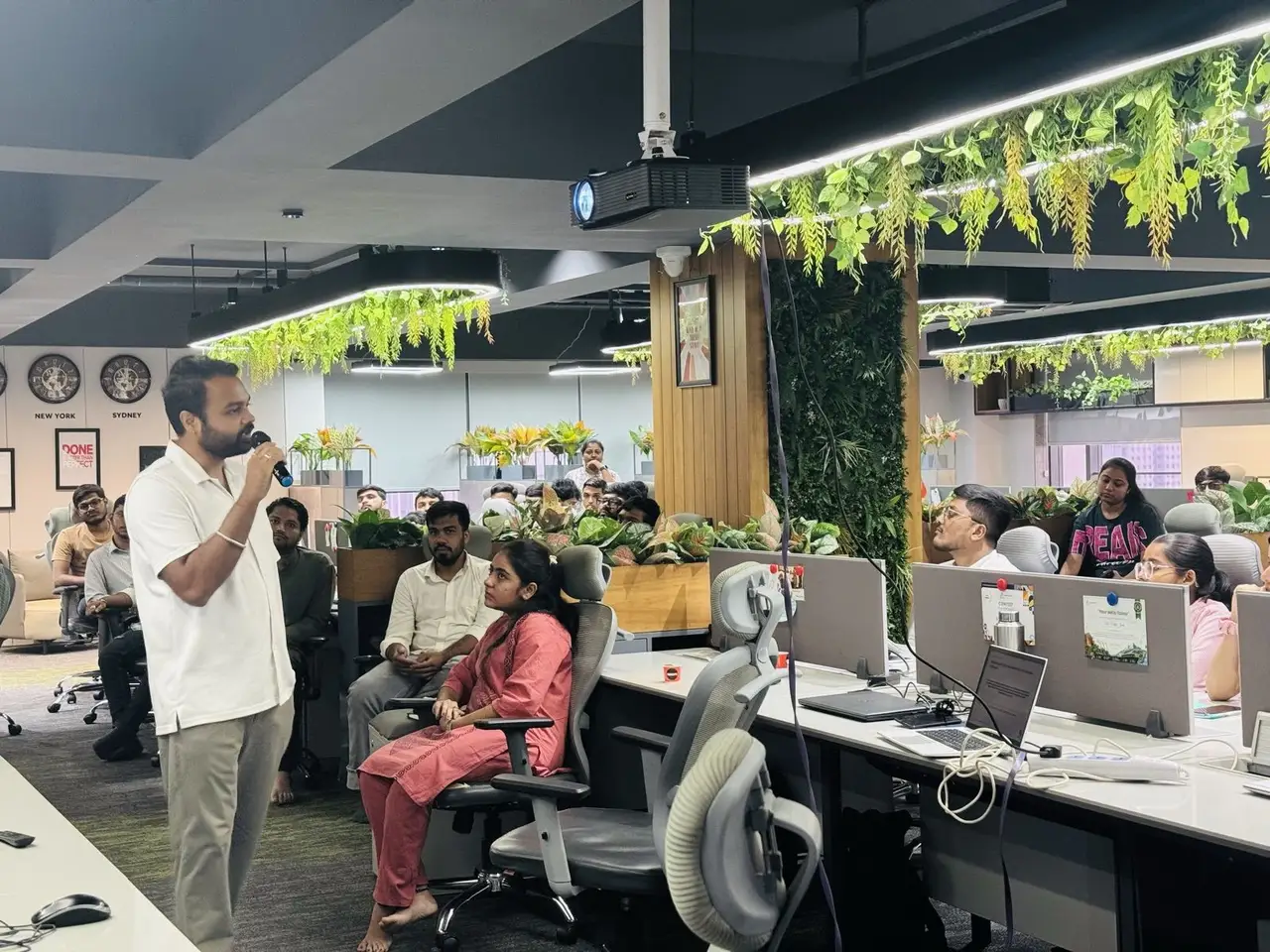 Anand Shrivastava with a microphone among Impero IT Services teams during AI training