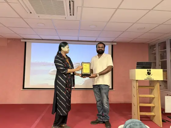 Anand Shrivastava receiving a memento from Indus University faculty